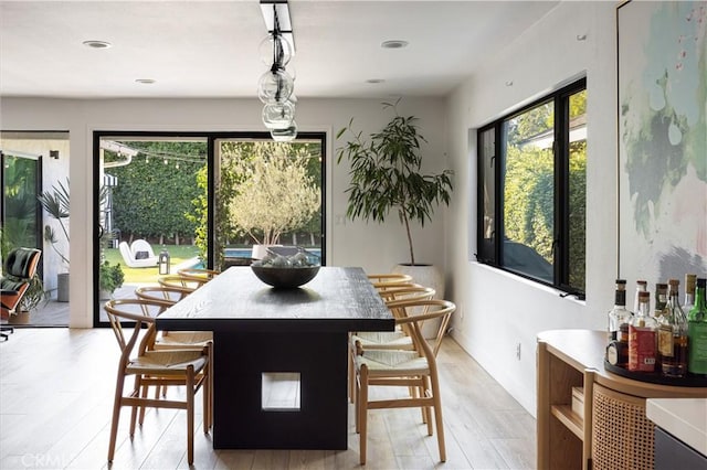 dining area with a healthy amount of sunlight and light wood-type flooring