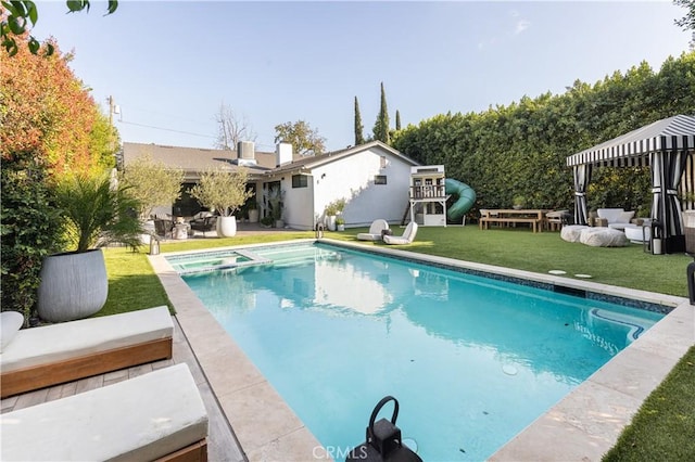 view of pool with a lawn and a patio