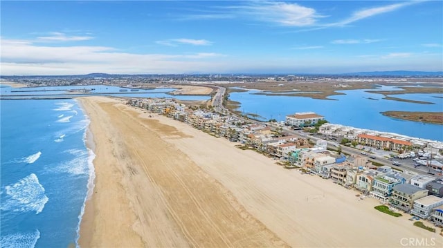 birds eye view of property featuring a water view and a view of the beach