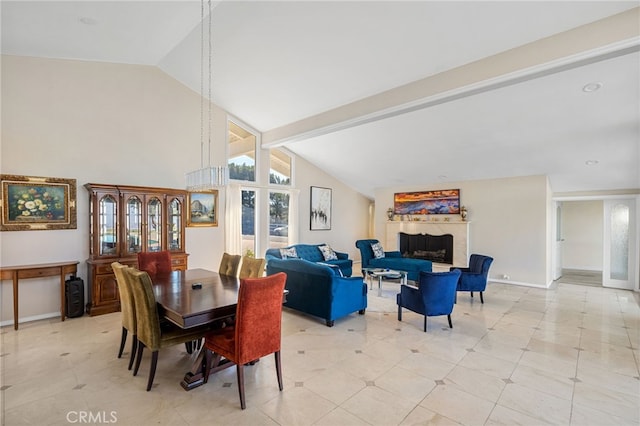 dining area featuring vaulted ceiling with beams