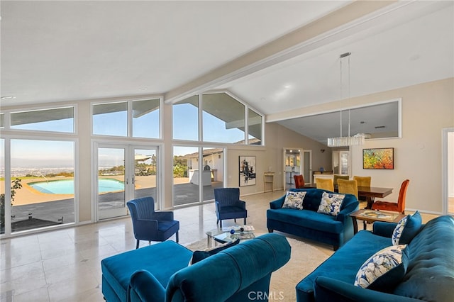 living room featuring vaulted ceiling with beams, french doors, and a notable chandelier