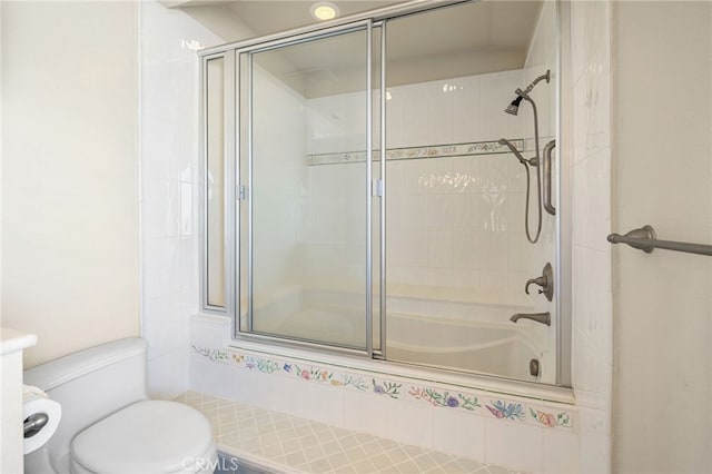 bathroom with enclosed tub / shower combo and toilet