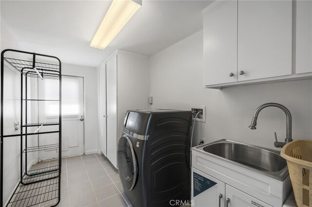 laundry room featuring washer / clothes dryer, sink, light tile patterned floors, and cabinets