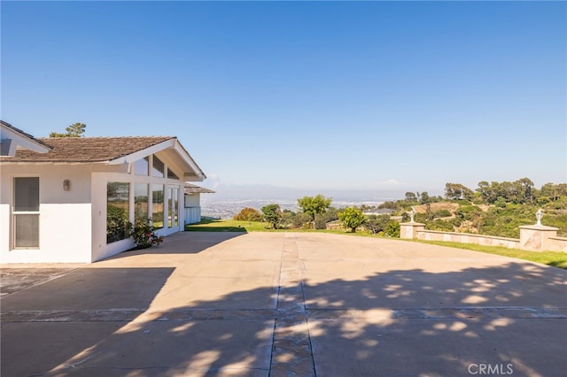 view of side of home with a patio