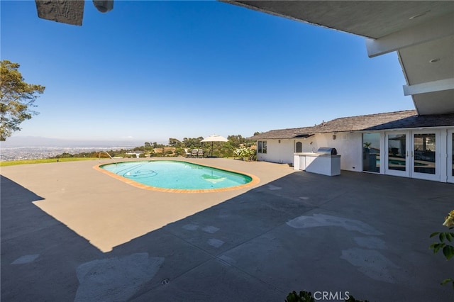 view of pool featuring french doors and a patio