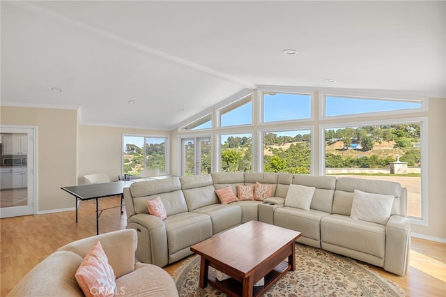 living room with vaulted ceiling with beams and light hardwood / wood-style flooring