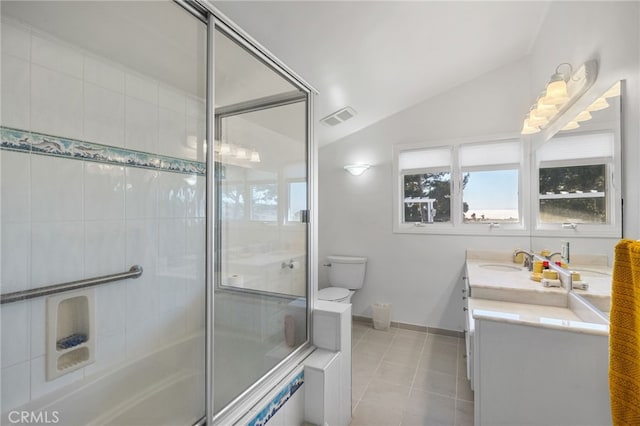 full bathroom with shower / bath combination with glass door, lofted ceiling, tile patterned floors, vanity, and toilet