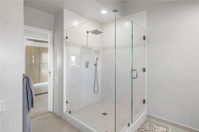 bathroom featuring walk in shower and tile patterned flooring