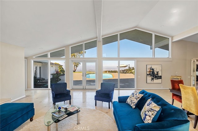 living room featuring a towering ceiling and french doors