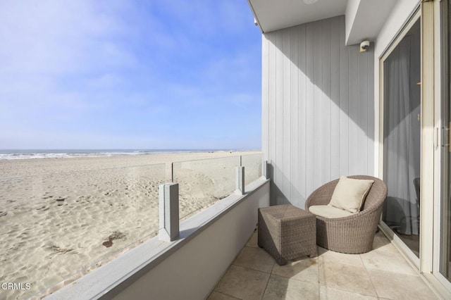 balcony with a beach view and a water view