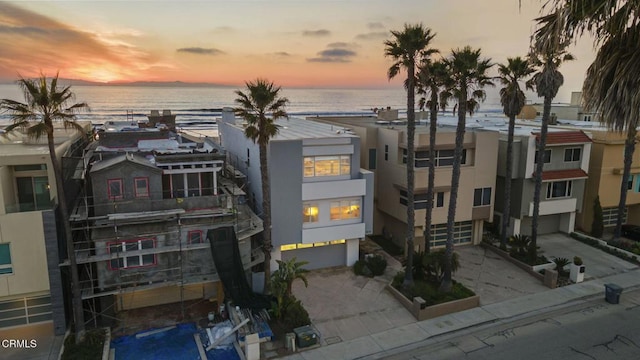 outdoor building at dusk featuring a garage and a water view