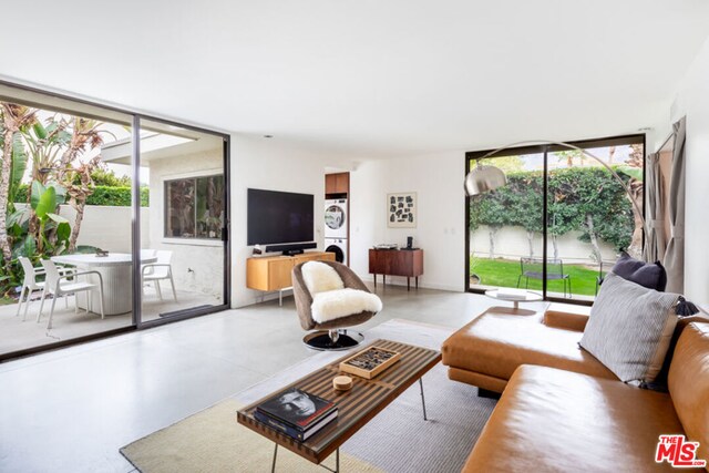 living room featuring expansive windows and concrete flooring