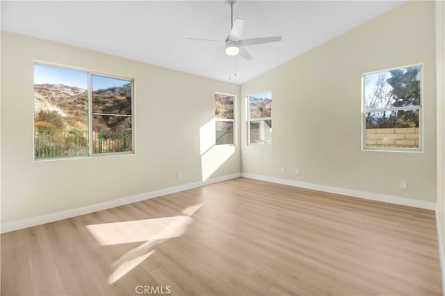 unfurnished room featuring ceiling fan, light wood-type flooring, and vaulted ceiling