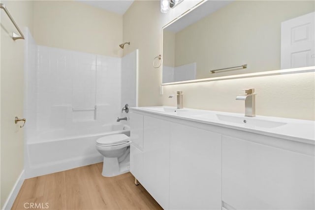 full bathroom featuring shower / bathtub combination, hardwood / wood-style floors, toilet, and vanity