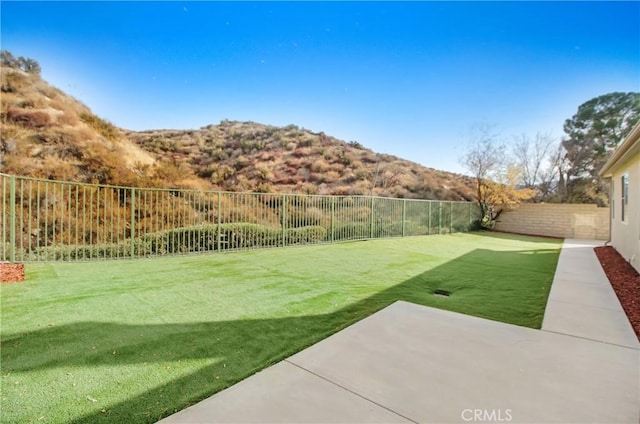 view of yard featuring a mountain view and a patio