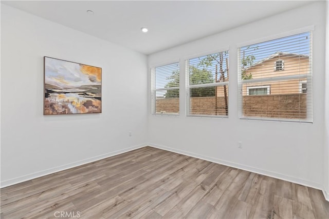 unfurnished room with light hardwood / wood-style floors