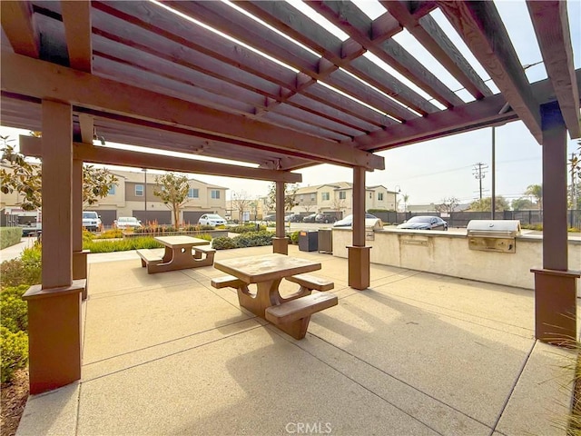 view of patio with an outdoor kitchen, area for grilling, and a pergola