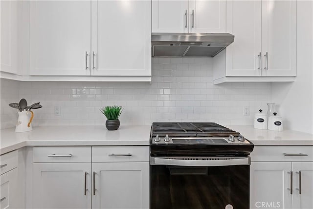 kitchen featuring backsplash, stainless steel gas range, and white cabinetry