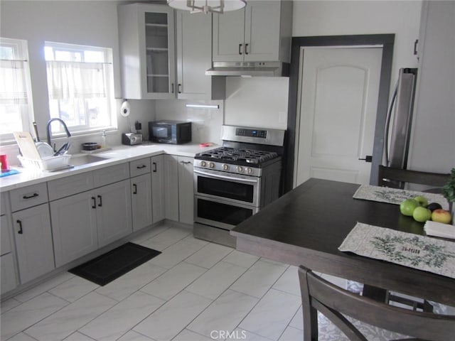 kitchen with gray cabinetry, sink, and stainless steel appliances