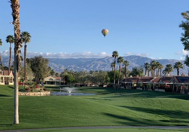 view of property's community featuring a mountain view and a yard