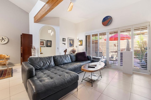 tiled living room with ceiling fan and beamed ceiling