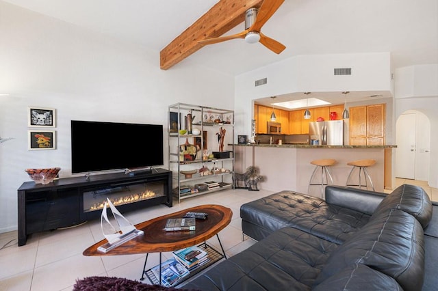 living room featuring ceiling fan, light tile patterned floors, high vaulted ceiling, and beam ceiling