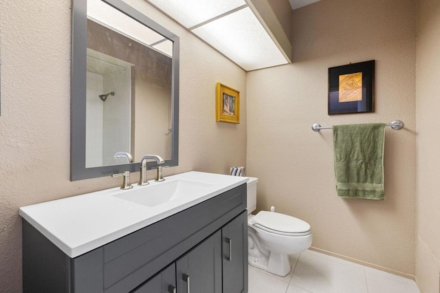 bathroom with toilet, tile patterned flooring, and vanity