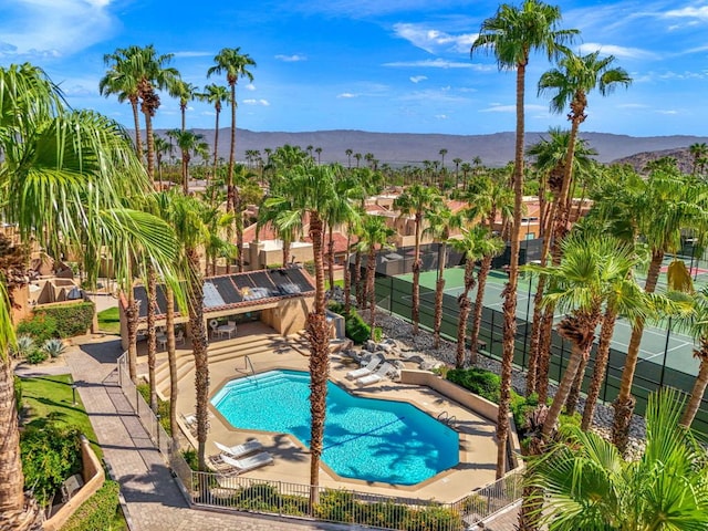 view of swimming pool with a mountain view and a patio