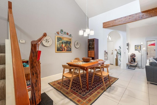 tiled dining space with high vaulted ceiling, beamed ceiling, and a chandelier