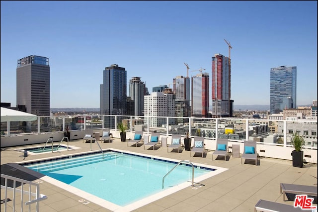 view of pool featuring a patio area and a community hot tub