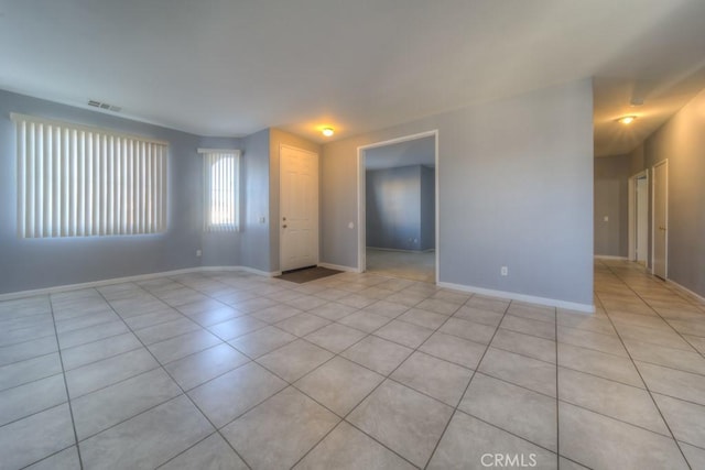 spare room featuring light tile patterned flooring