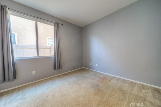 carpeted empty room featuring plenty of natural light