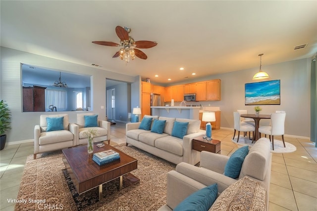 living room featuring ceiling fan and light tile patterned flooring