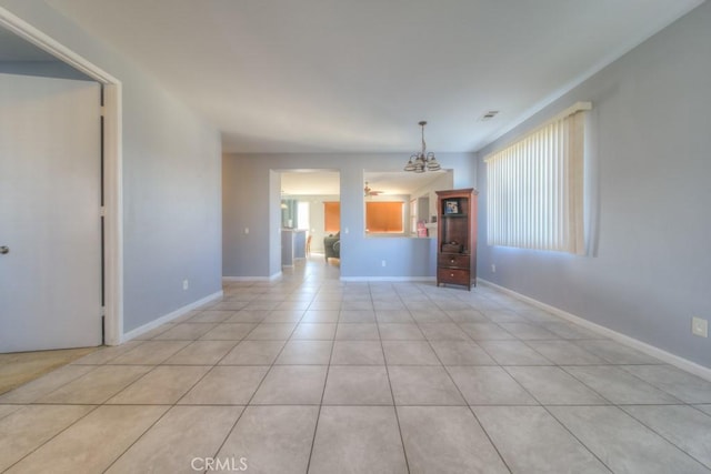 unfurnished living room with light tile patterned floors and a chandelier