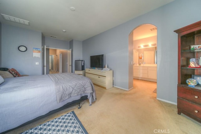 carpeted bedroom with ensuite bathroom