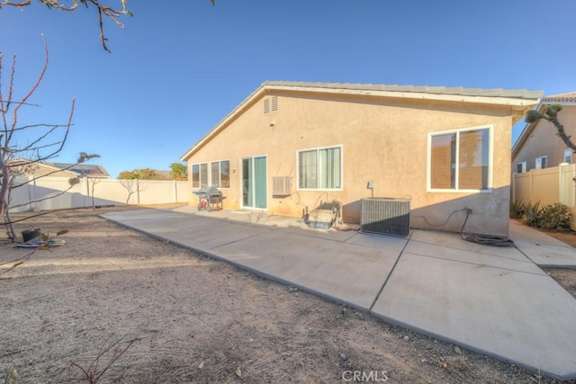 back of property featuring central AC unit and a patio