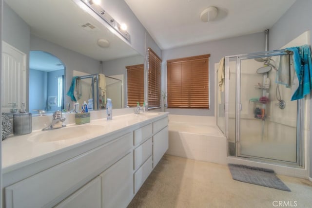 bathroom featuring vanity and plus walk in shower