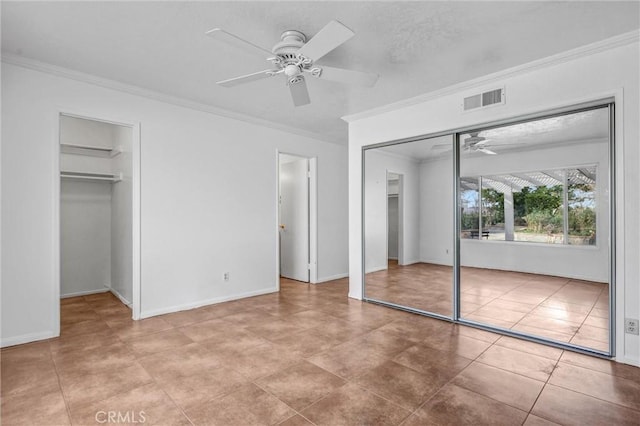 unfurnished bedroom with ceiling fan, a textured ceiling, light tile patterned floors, and crown molding