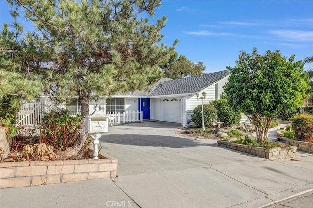 view of property hidden behind natural elements with a garage