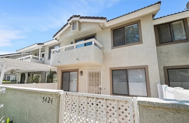 back of property featuring a pergola