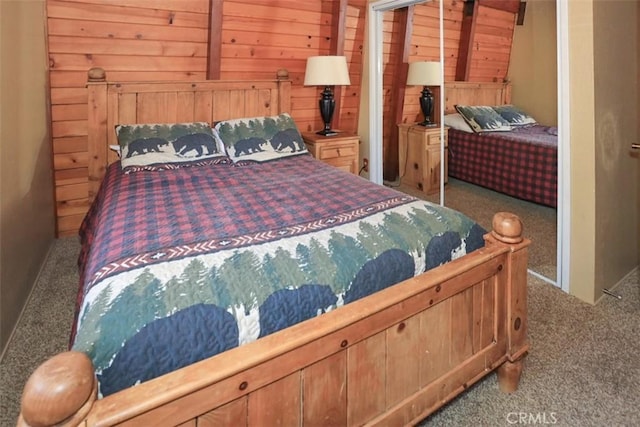 carpeted bedroom featuring wood walls