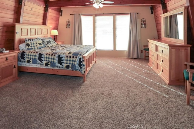 carpeted bedroom featuring ceiling fan and wooden walls