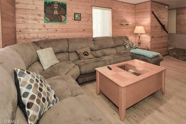 living room with wood walls and light hardwood / wood-style floors