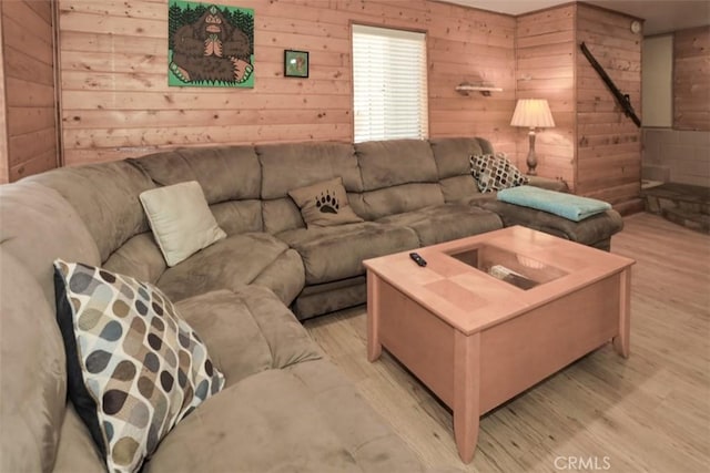 living room with wooden walls and light wood-style floors