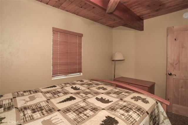 unfurnished bedroom with beamed ceiling and wood ceiling