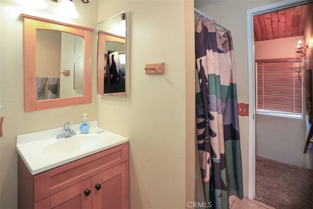 bathroom featuring vanity and a shower with curtain