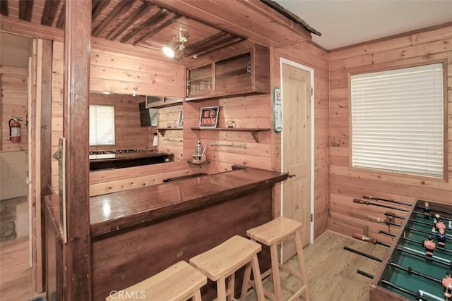 kitchen featuring wood walls, open shelves, and wood finished floors