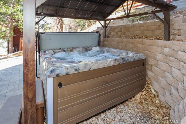 view of patio / terrace featuring a hot tub