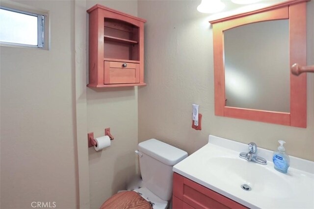 bathroom featuring toilet and vanity