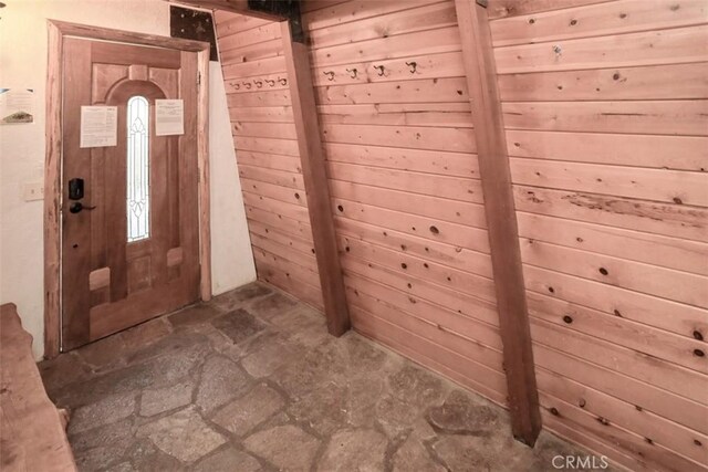 entrance foyer featuring wooden walls